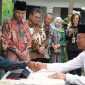 Menteri Koordinator Bidang Pembangunan Manusia dan Kebudayaan (Menko PMK) Muhadjir Effendy menyerahkan zakat di Taman Masjid Nurussalam Kemenko PMK pada Jumat (14/3/2023). (Foto:Pelopor.id/Kemenko PMK)